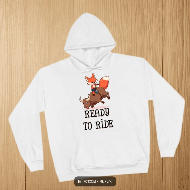 Funny red fox in chaps, on a bucking mechanical bull, printed on a warm hoodie for a humorous and cozy feel.